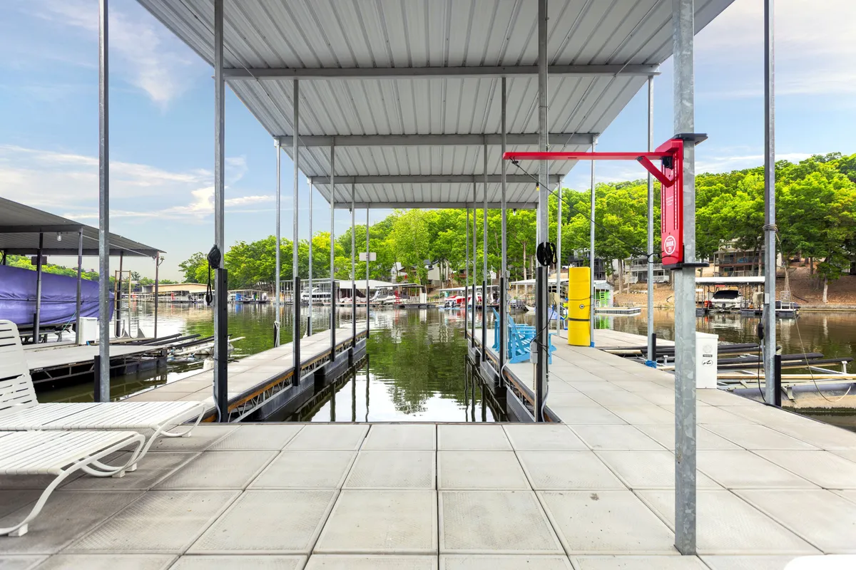 Shown here are docks extending into the water, with boats, water reflections, and green trees lining the shore. The area invites boating, fishing, or simply sitting dockside—activities that would appeal to families or friend groups looking to explore and enjoy the lake together.